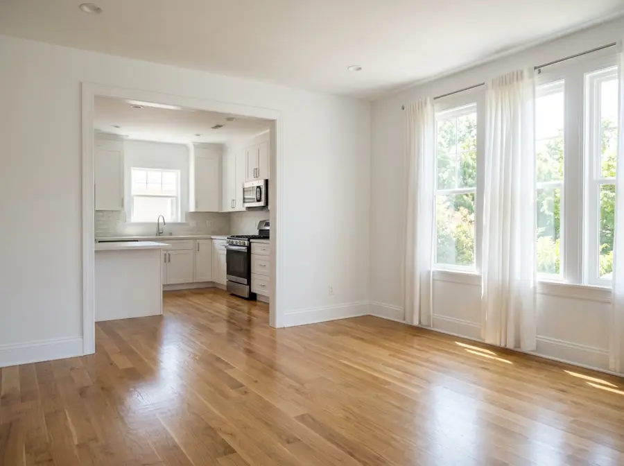 Bright, empty rental home with clean hardwood floors and sunlit windows